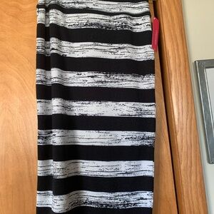 This is an Xhilaration pencil skirt. It is black made of knit fabric.